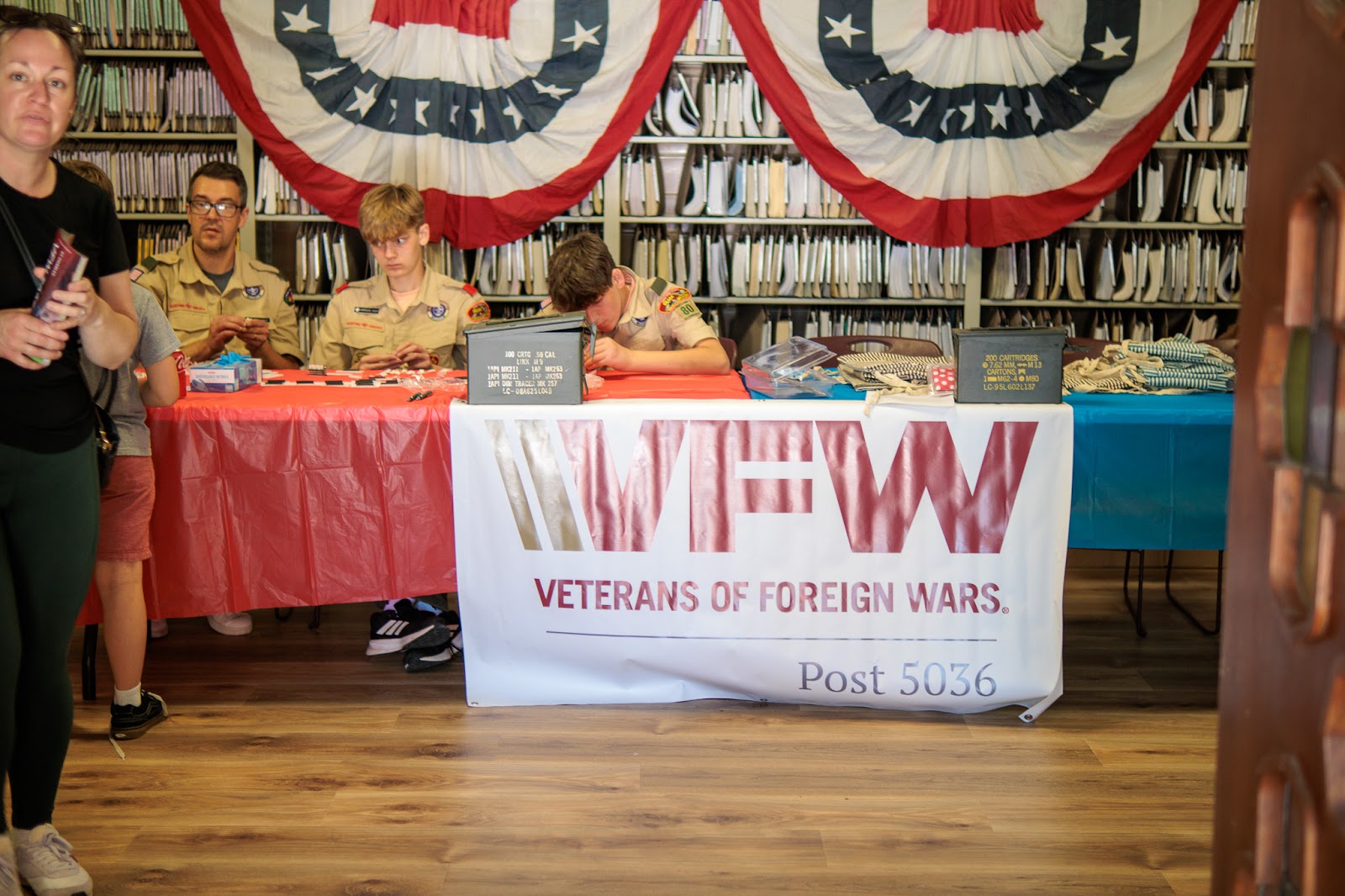 Scouts prepare a welcome table for a St. Charles community gathering
