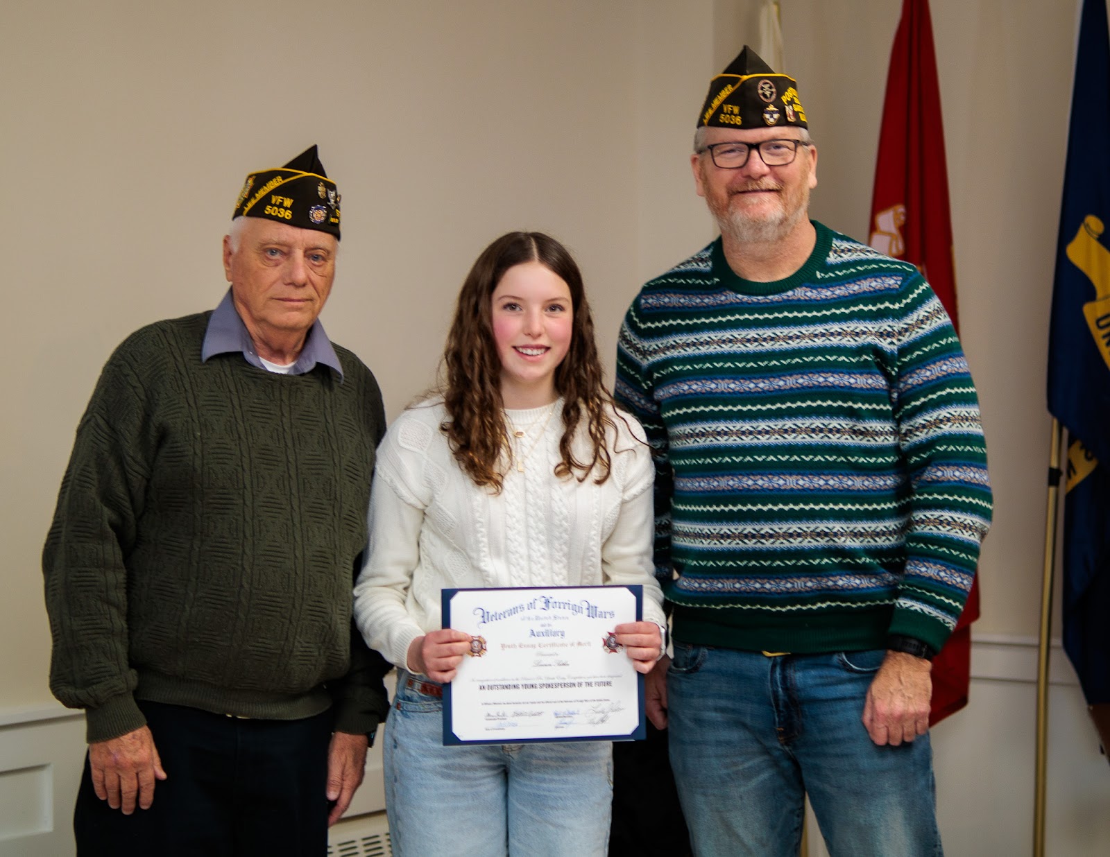 A student receives recognition from Post 5036 veterans at a Patriot's Pen gathering