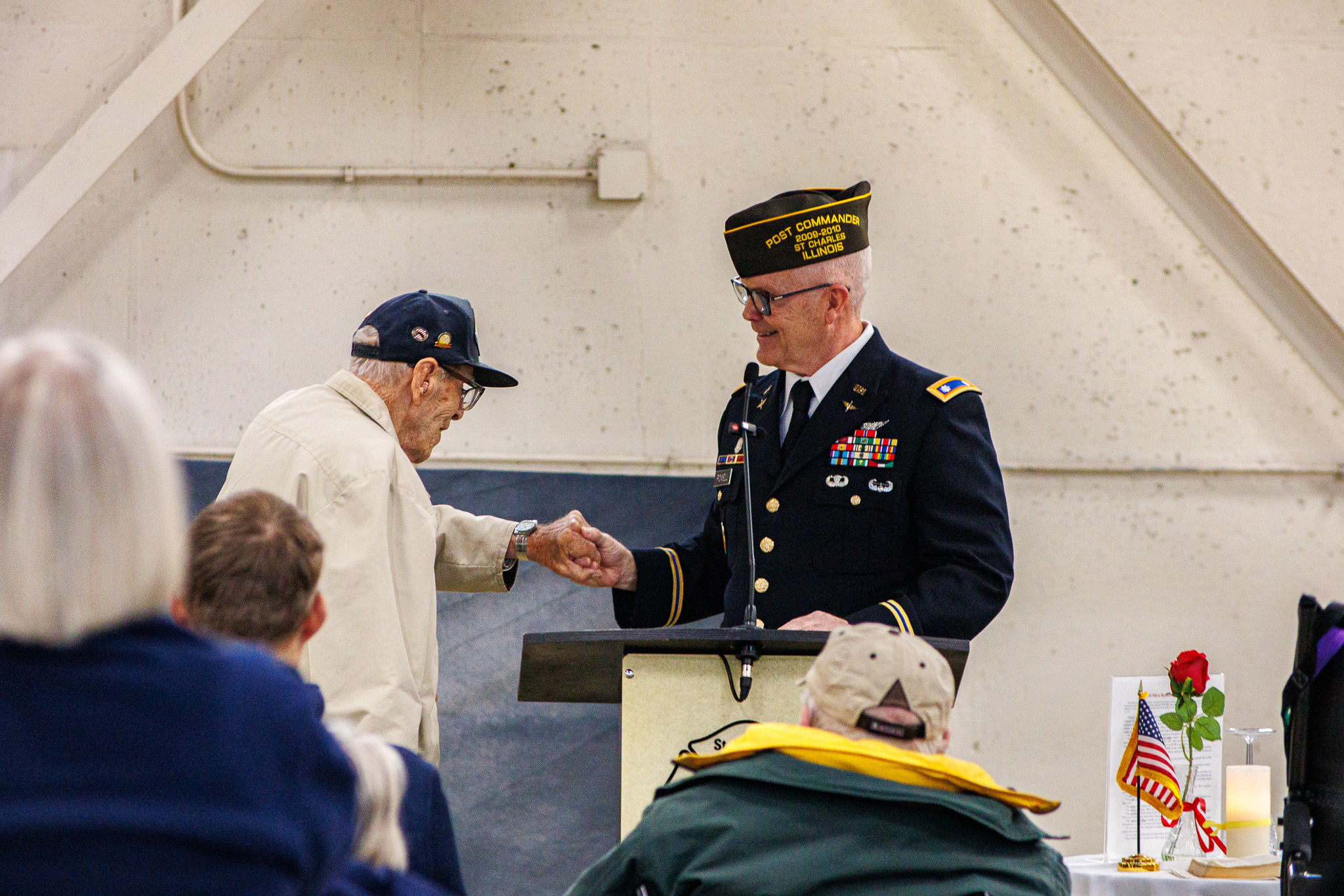 Two local veterans share a handshake during a Post 5036 gathering
